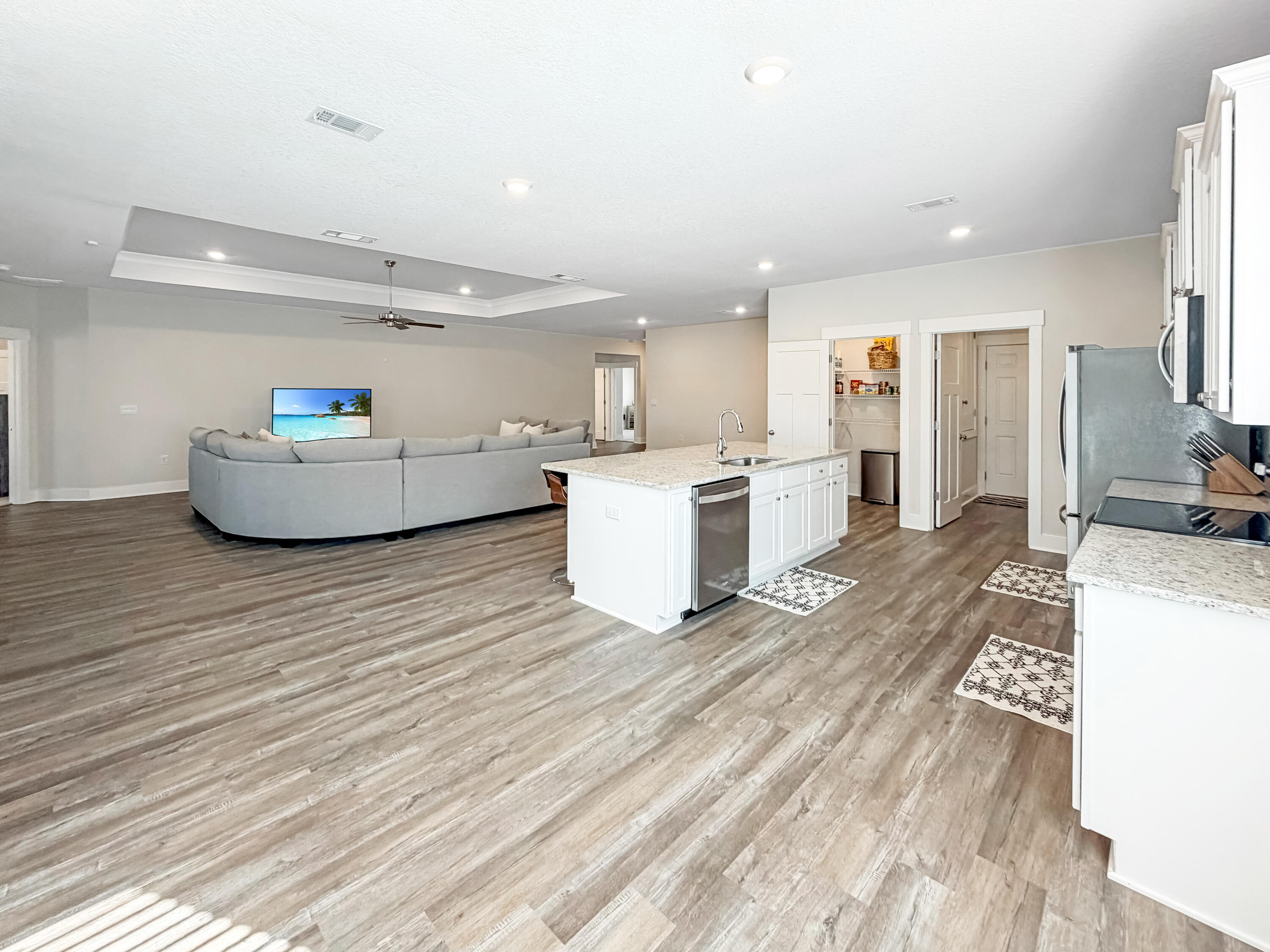 722 Quintana Street Crestview, FL 32539 - Photo 7 of 36 a living room with a couch and a wooden floor