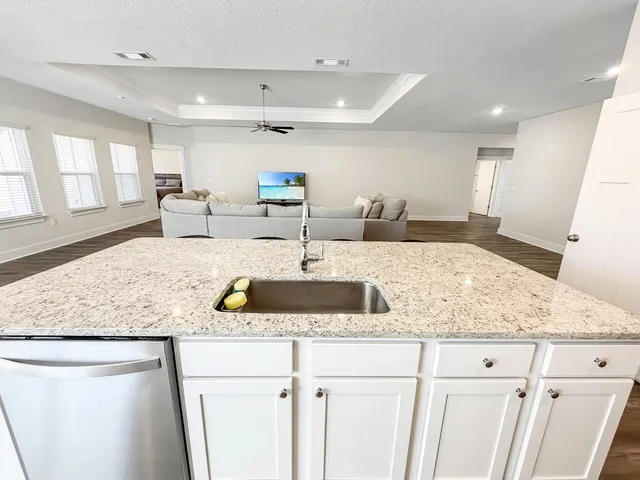 a kitchen with stainless steel appliances granite countertop a stove refrigerator and cabinets