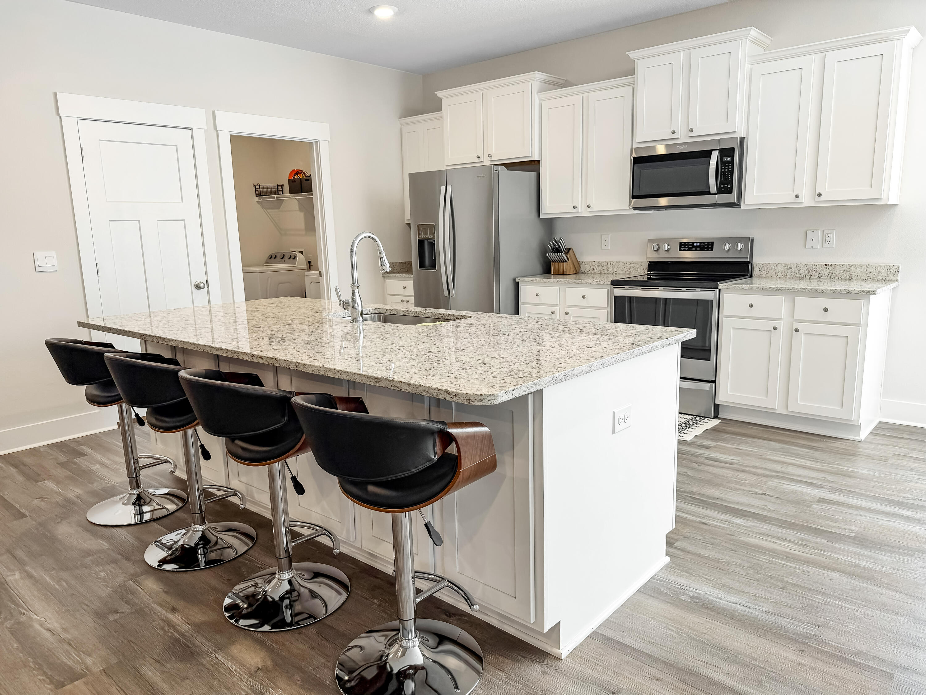 722 Quintana Street Crestview, FL 32539 - Photo 10 of 36 a kitchen with a sink a microwave a refrigerator and cabinets