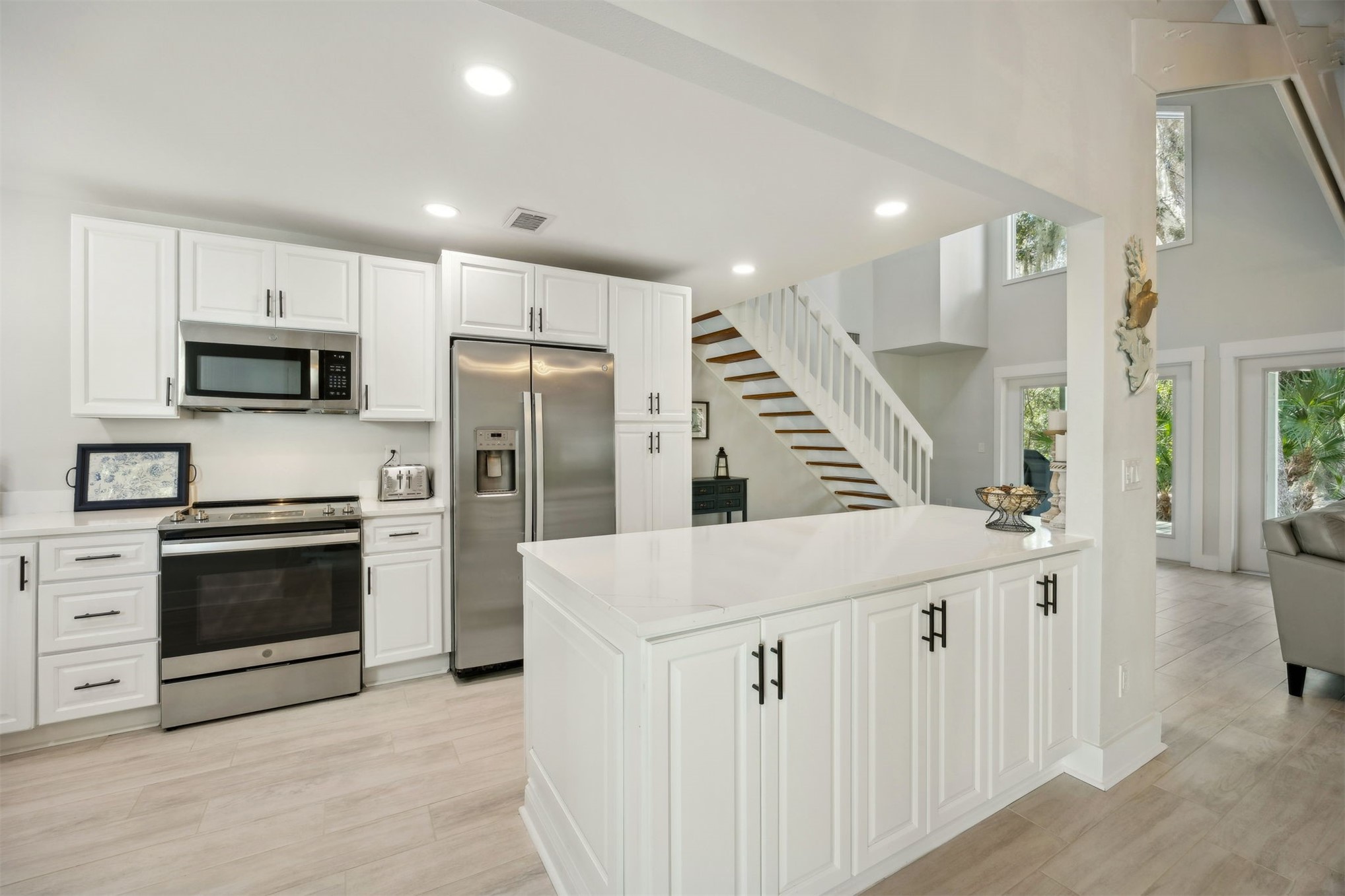 22 Beachwood Road Fernandina Beach, FL 32034 - Photo 25 of 100 a kitchen with kitchen island a stove a sink and a refrigerator with wooden floor