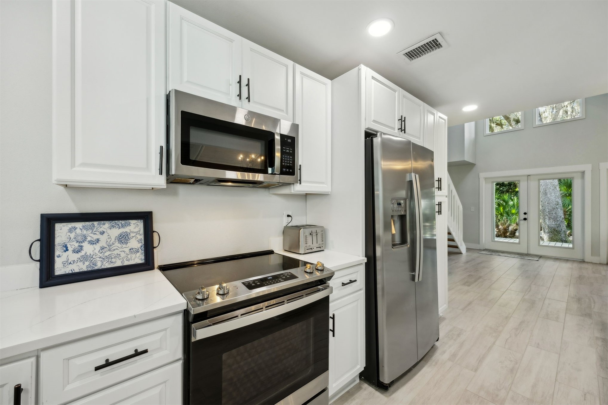 22 Beachwood Road Fernandina Beach, FL 32034 - Photo 27 of 100 a kitchen with stainless steel appliances a stove a microwave and cabinets