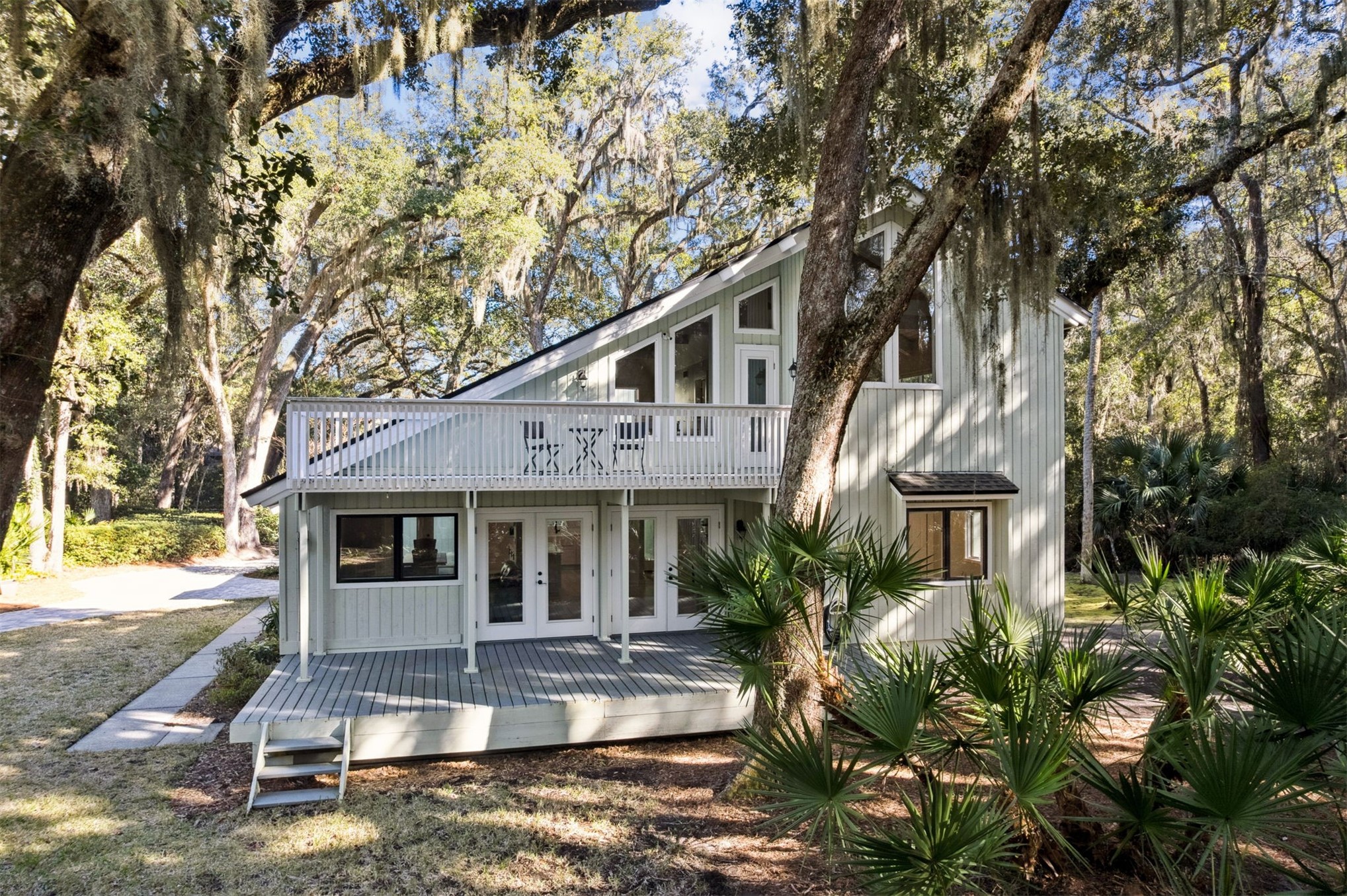 22 Beachwood Road Fernandina Beach, FL 32034 - Photo 79 of 100 a front view of a house with a yard garage and outdoor seating