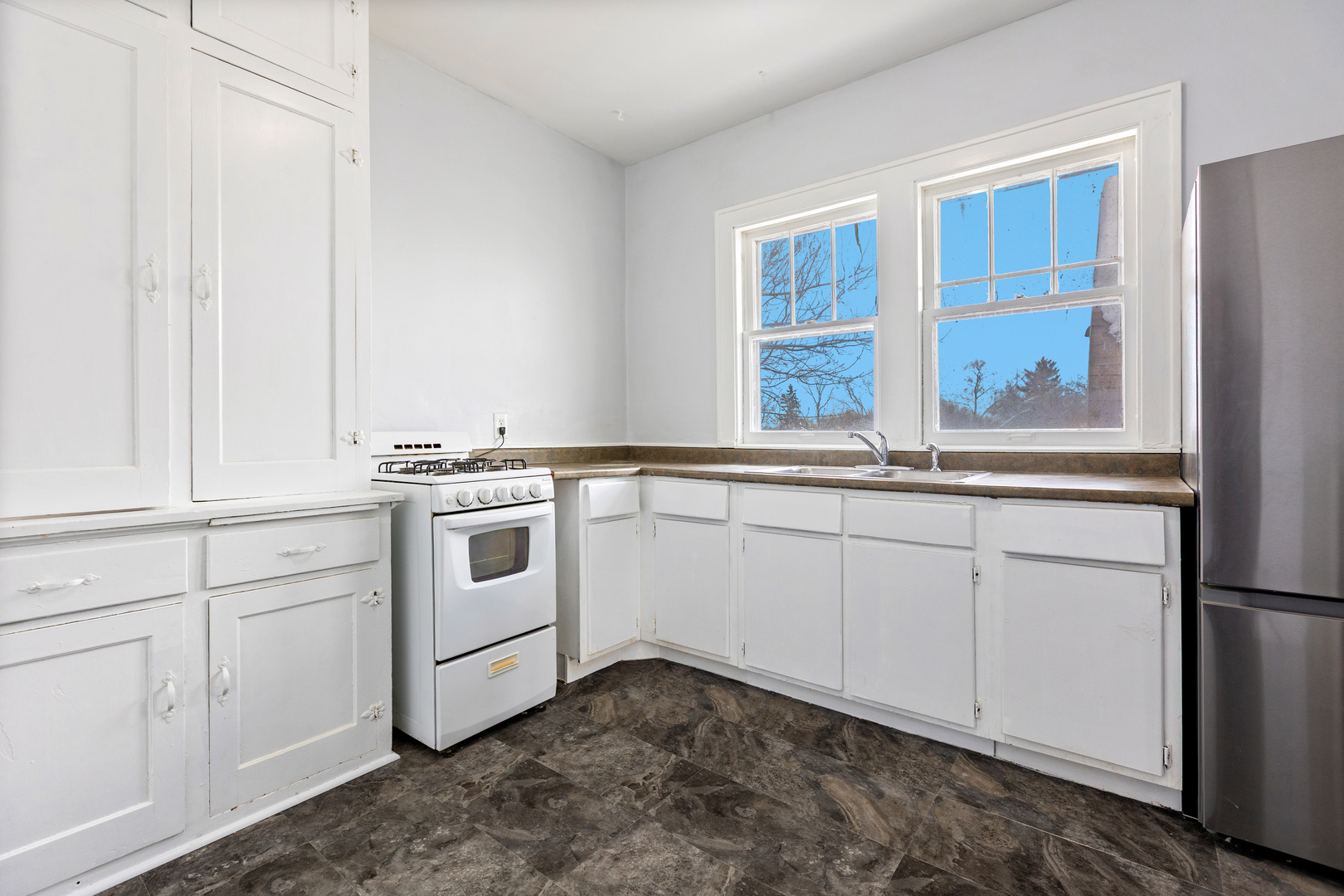518 South Street Elgin, IL 60123 - Photo 12 of 22 a kitchen with white cabinets and white appliances