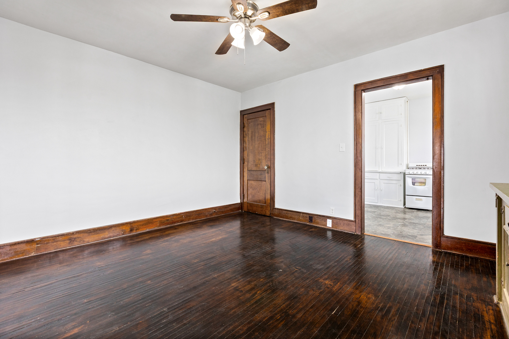 518 South Street Elgin, IL 60123 - Photo 8 of 22 a view of an empty room with wooden floor and a ceiling fan