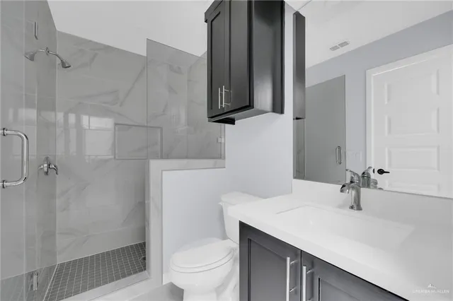 a bathroom with a sink toilet and shower