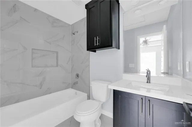 a bathroom with a sink a toilet and bathtub