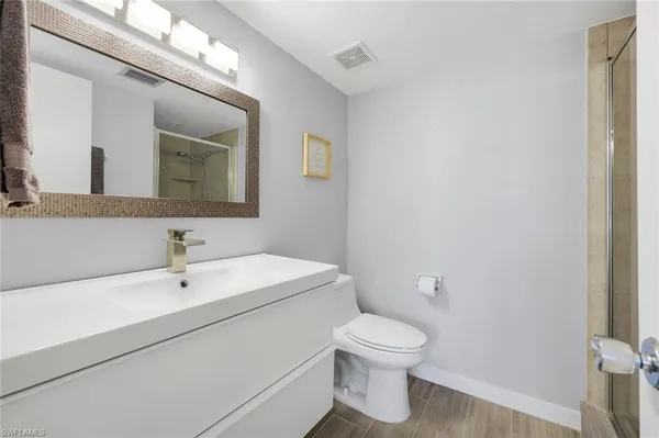 a white toilet sitting next to a bathroom sink