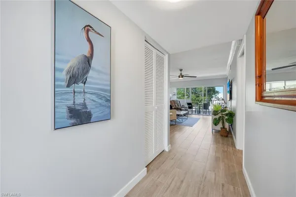 a view of a hallway to dining room and livingroom with furniture