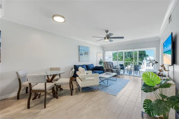 a living room with furniture and a floor to ceiling window