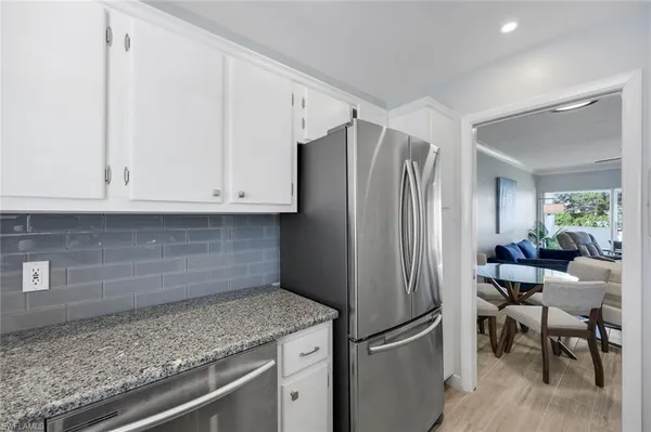 a kitchen with stainless steel appliances granite countertop a refrigerator and a sink