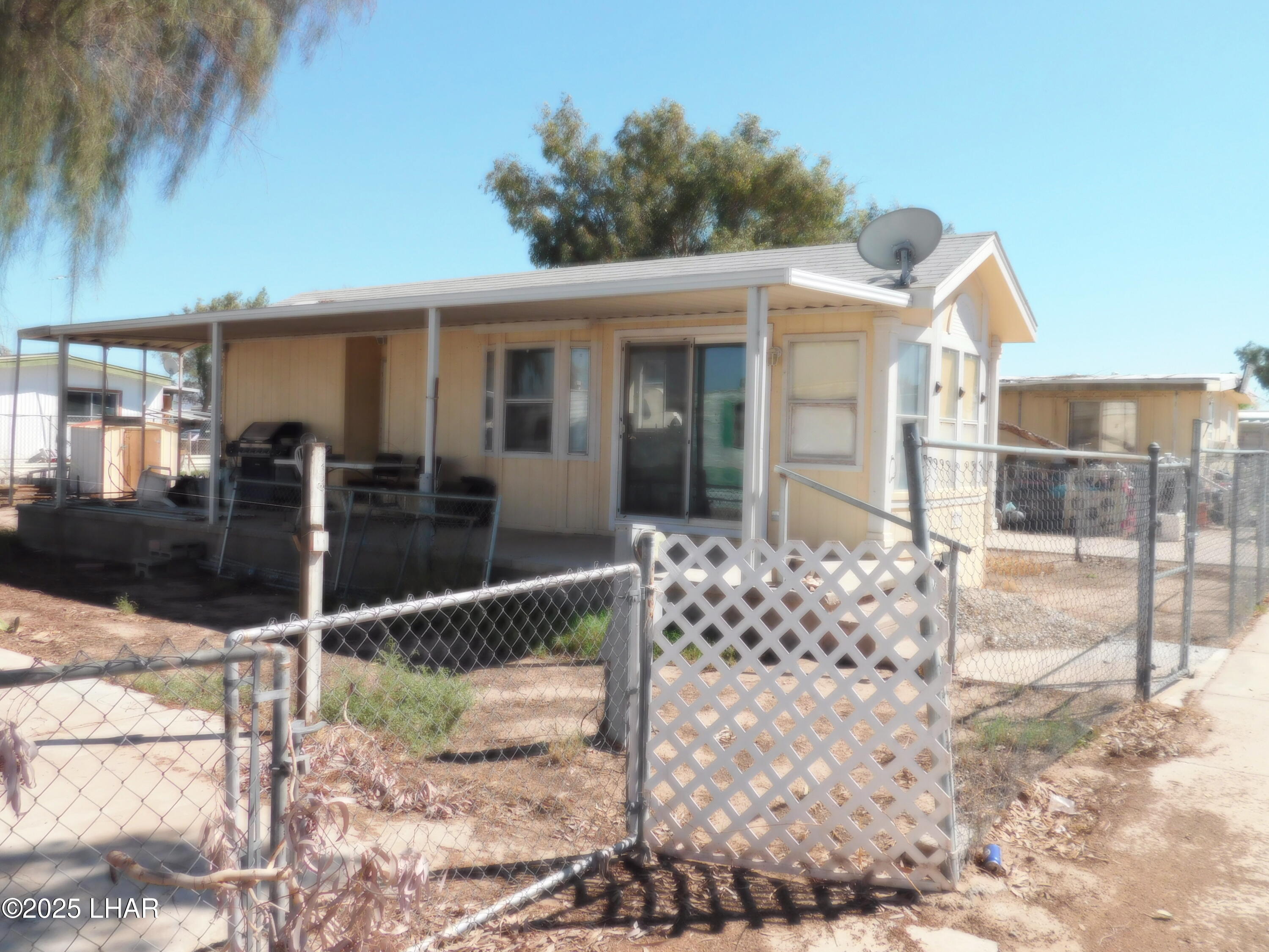 48792 Sourdough Road, Unit 27 Ehrenberg, AZ 85334 - Photo 2 of 4 a view of a house with large windows and couches