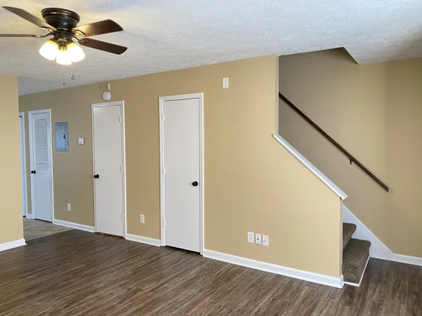 a view of room with hardwood floor and hallway