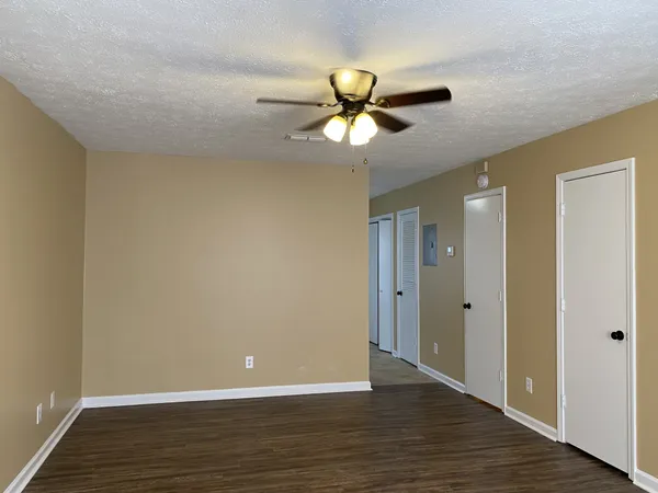 a view of an empty room with wooden floor