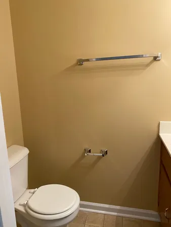 a white toilet sitting next to a shower