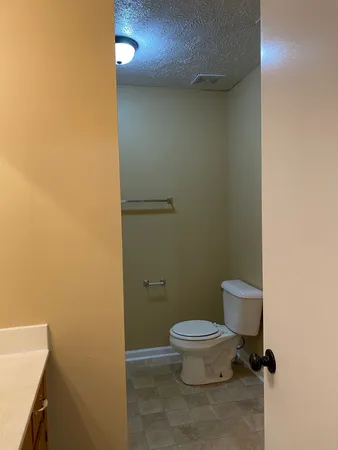 a white toilet sitting next to a bathroom sink