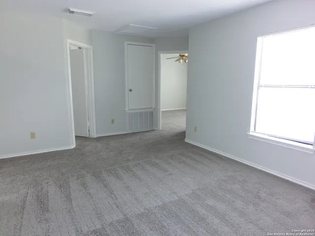 an empty room with windows and closet