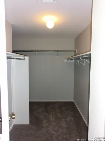 a view of storage and utility room with closet