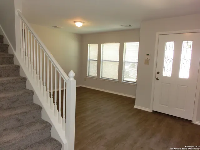 a view of an entryway with wooden floor