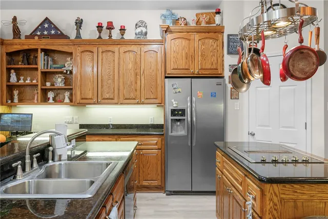 a kitchen with stainless steel appliances granite countertop a stove and a sink