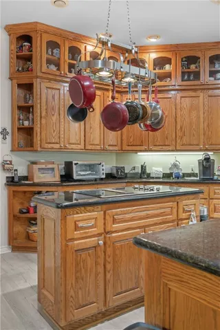 a kitchen with stainless steel appliances granite countertop a stove and cabinets