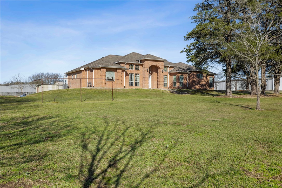 128 Duke Road Bedias, TX 77831 - Photo 5 of 49 a big house with a big yard and large trees