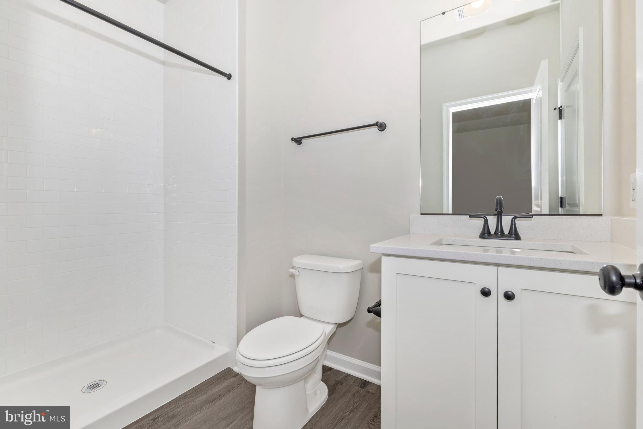 113 Spring Bank Way Frederick, MD 21701 - Photo 3 of 13 a bathroom with a sink a toilet and a mirror