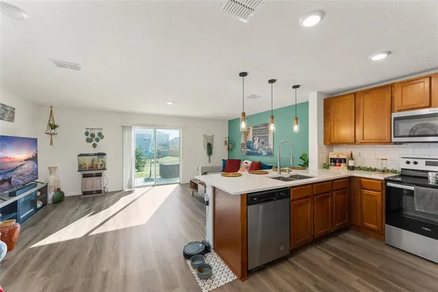 a kitchen with a sink stove and cabinets