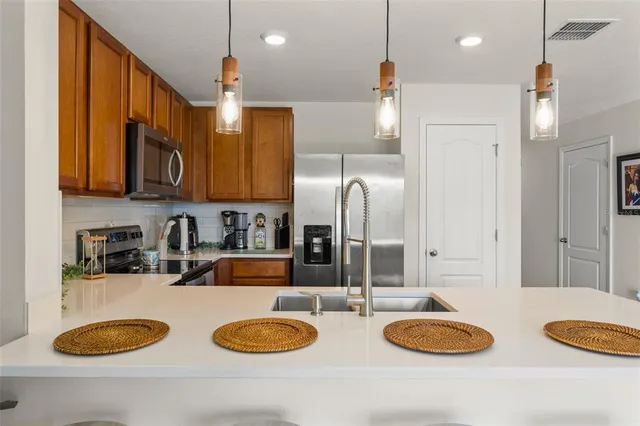 a kitchen with refrigerator and a sink