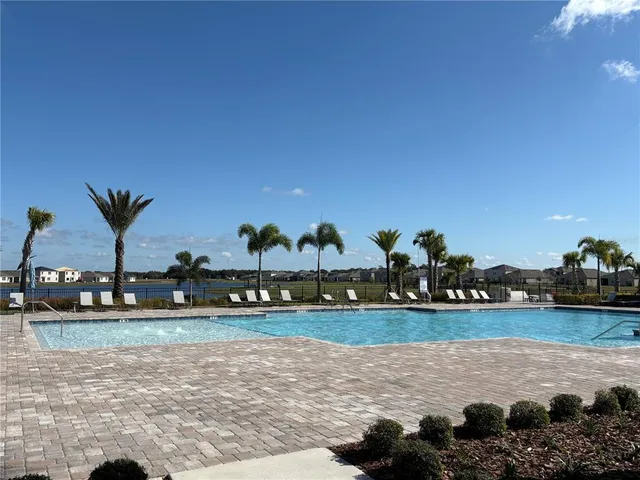 a view of a house with backyard porch and sitting area