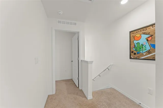 a view of a hallway with paintings on the wall