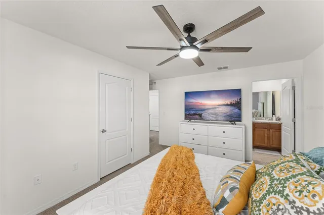 a bedroom with a bed and a flat screen tv