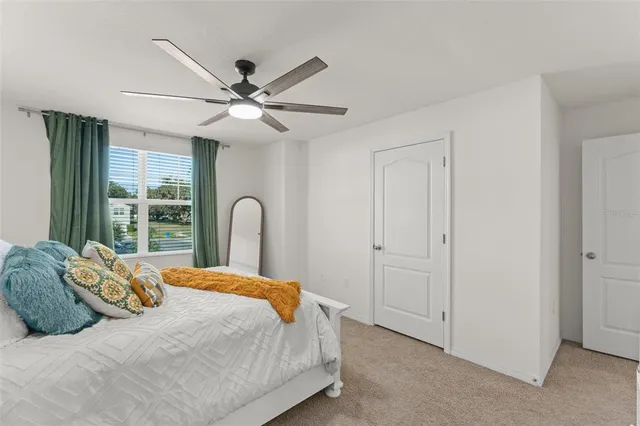 a bedroom with a large bed and a chandelier