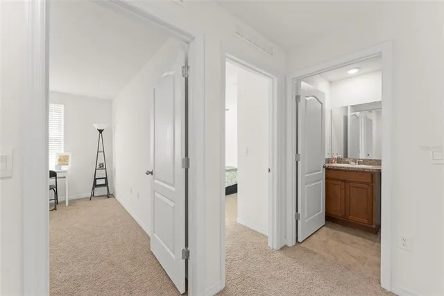 a view of a hallway with closet and a living room