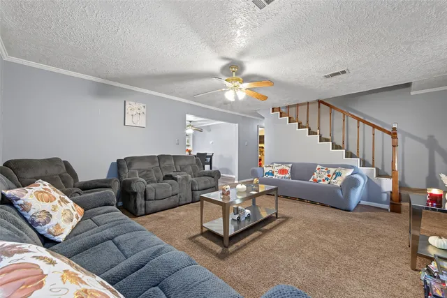 a living room with furniture and a chandelier