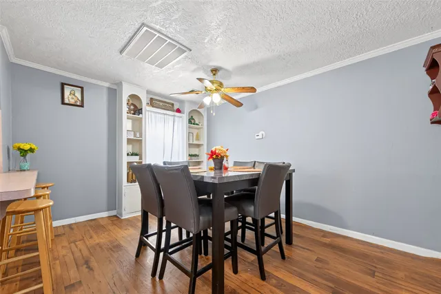 a dining room with furniture and wooden floor