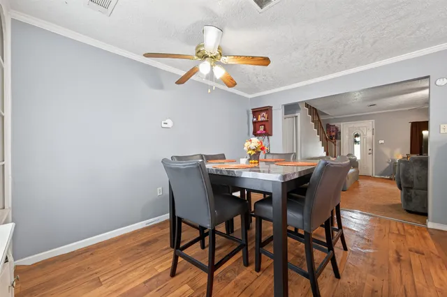 a view of a dining room with furniture and wooden floor