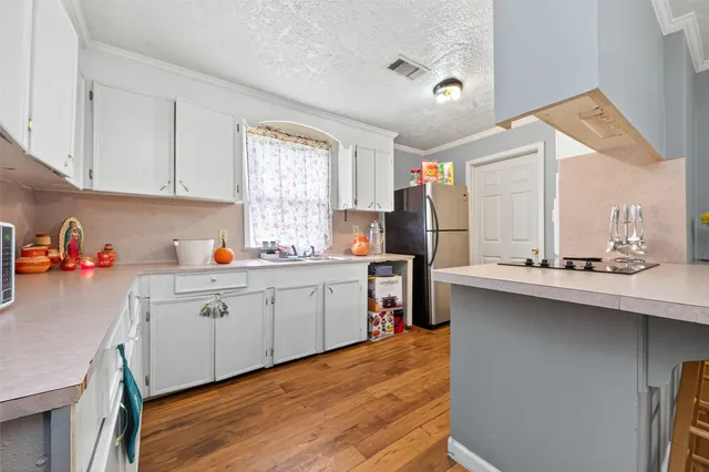 a kitchen with a sink stove and cabinets