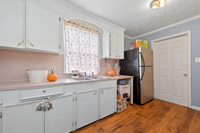 a kitchen with stainless steel appliances a refrigerator sink and cabinets