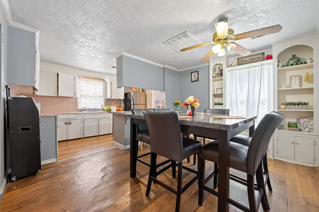 a view of a dining room with furniture and chandelier