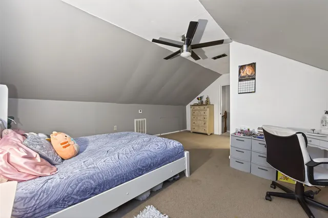 a bedroom with a bed and a chair