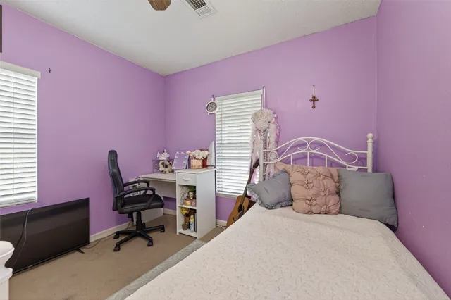 a bedroom with a bed and a desk