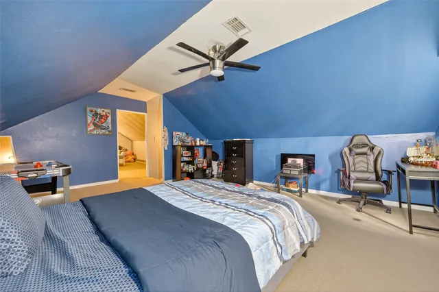 a bed room with a bed and a chair