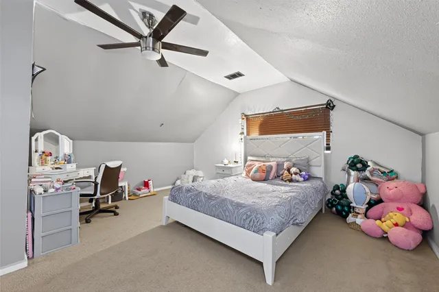 a bedroom with a bed and a table