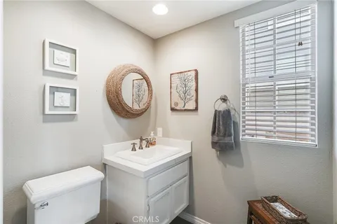 a bathroom with a toilet a sink and a mirror