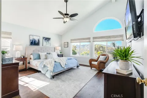 a bedroom with a bed couch and window