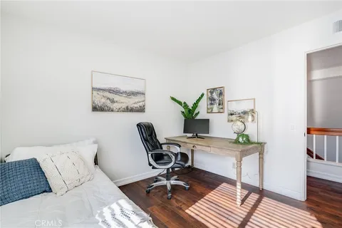 a work room with furniture and wooden floor
