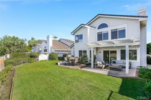 a front view of a house with sitting area and garden