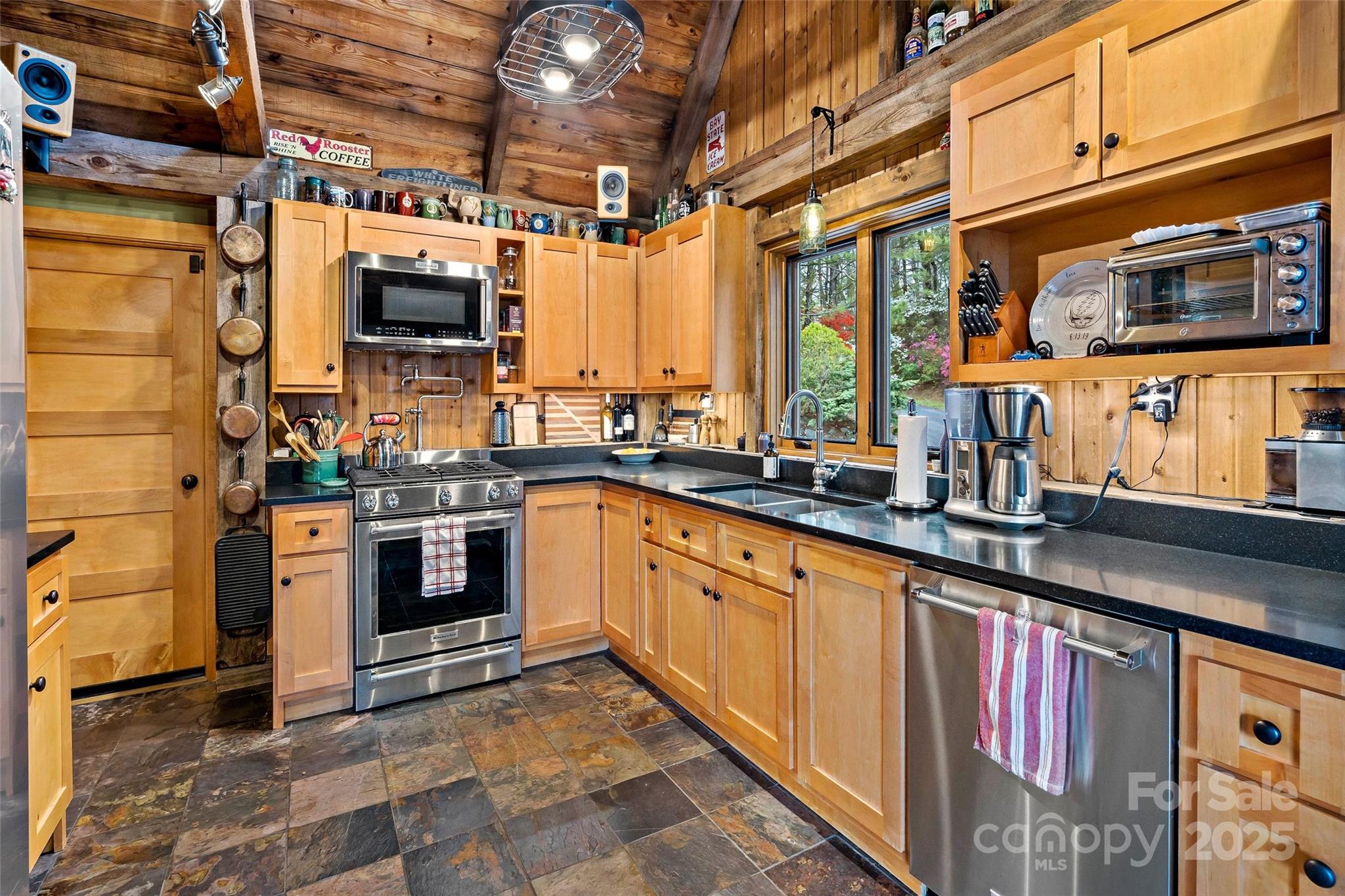 692 Hidden Acres Drive Marion, NC 28752 - Photo 16 of 48 a kitchen with stainless steel appliances a stove sink and microwave