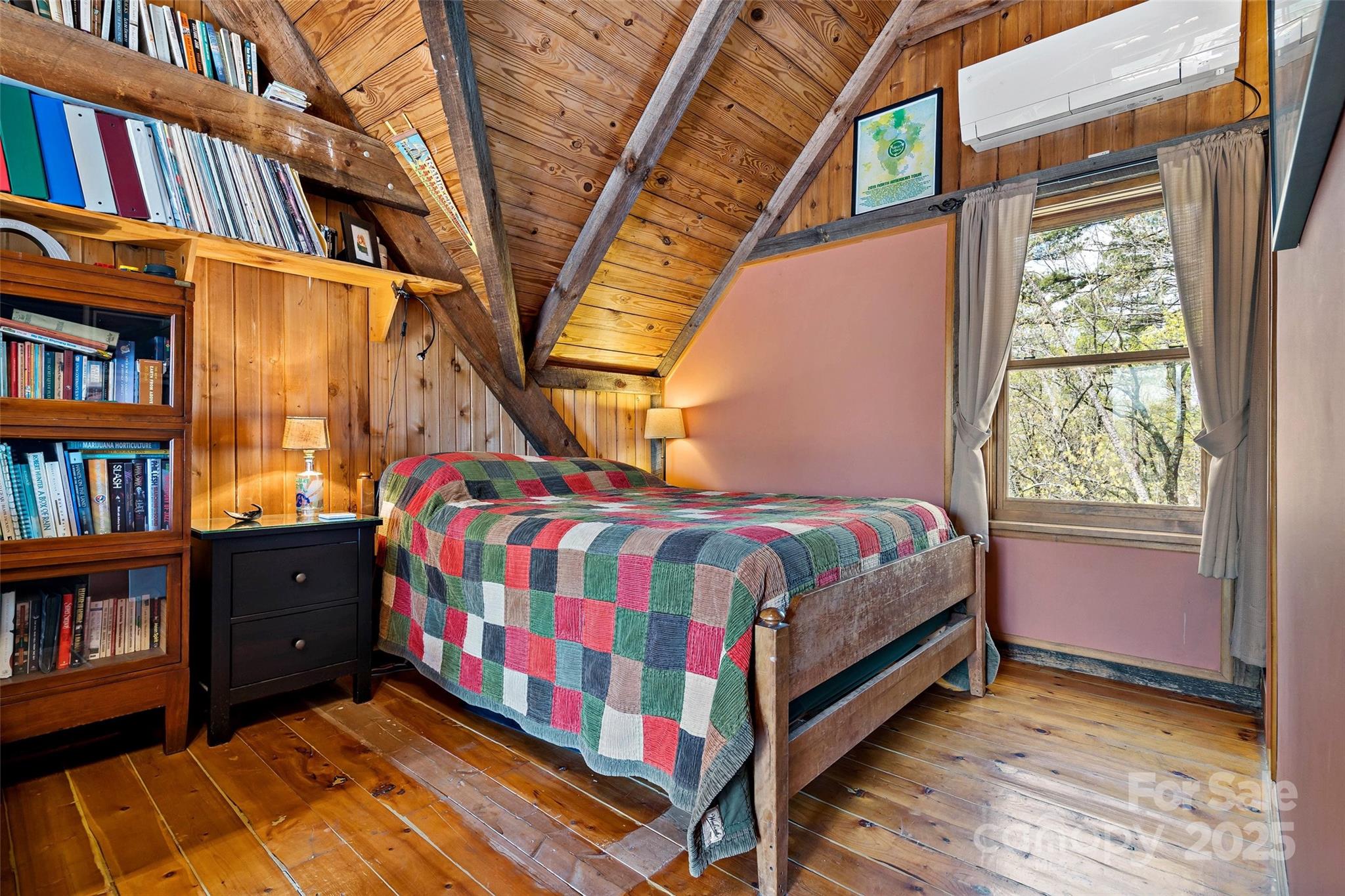 692 Hidden Acres Drive Marion, NC 28752 - Photo 26 of 48 a bed sitting in a bedroom next to a book shelf