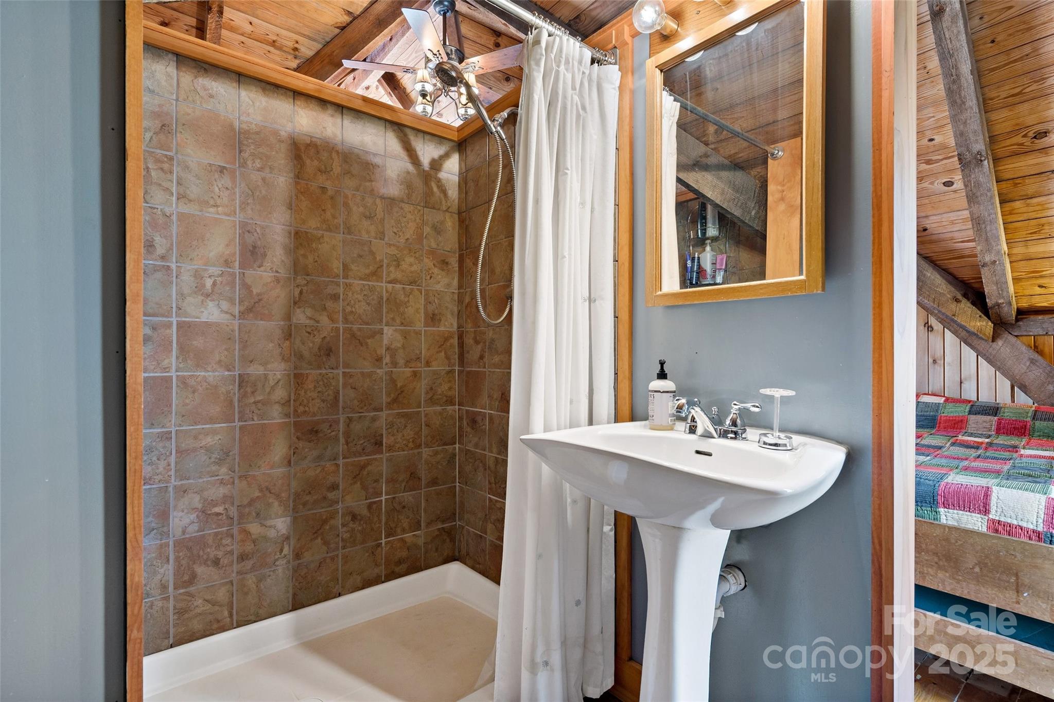 692 Hidden Acres Drive Marion, NC 28752 - Photo 28 of 48 a bathroom with a sink mirror and shower